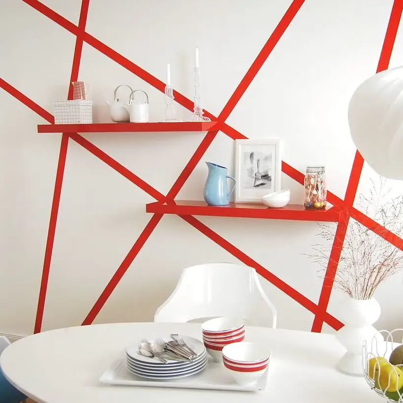 Vægdesign med røde striber ved hjælp af tesa® malertape. Et innovativt og unikt vægdesign til dit hjem.