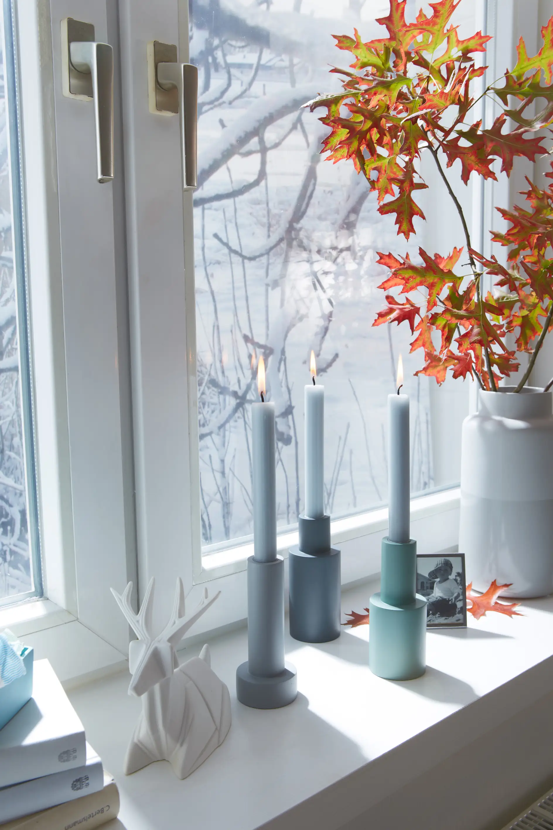 Candles in front of an insulated window in winter
