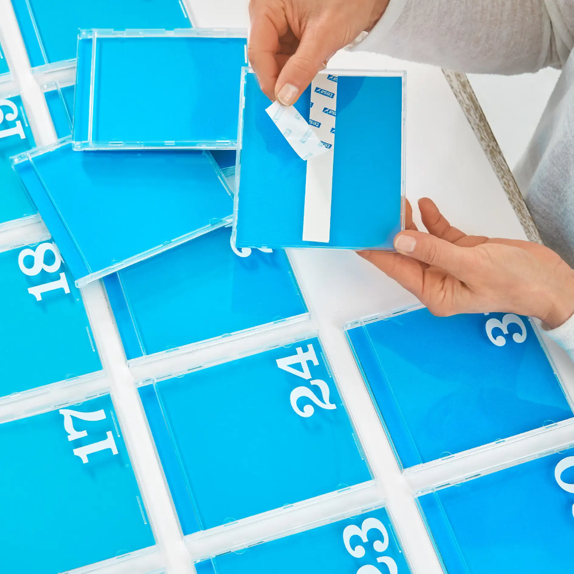 Making a DIY calendar – removing the backing from tesa® Mounting Tape for Tiles & Metal