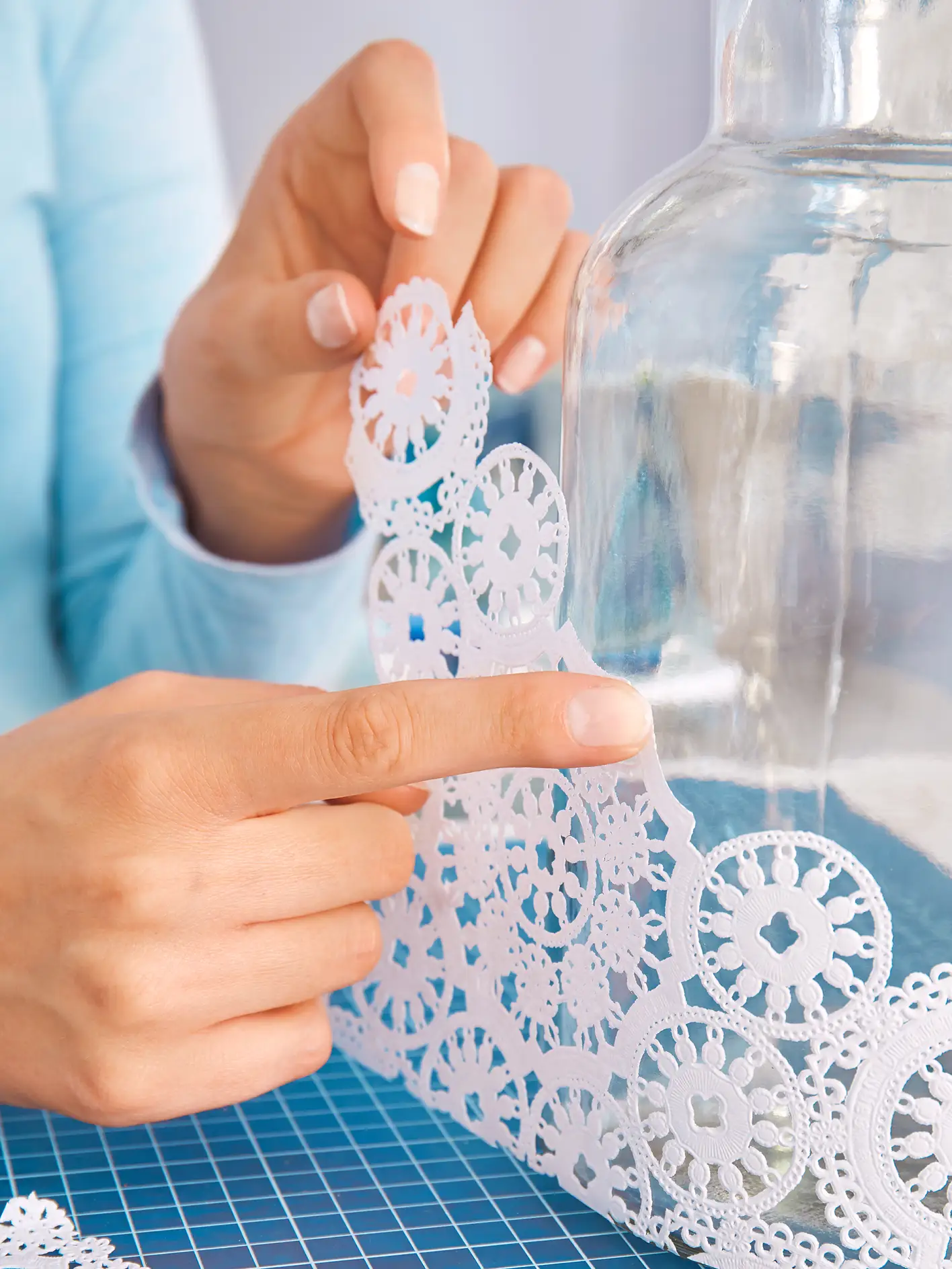 Position and stick the doily to the glass vase to create your own DIY vase