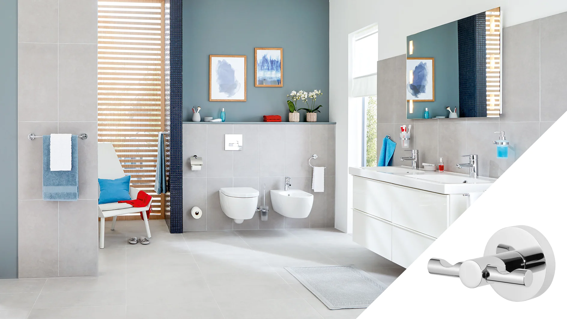 Moderní koupelna s šedými obklady obsahuje závěsné WC a bidet, bílé umyvadlo s dvojitým umyvadlem a dřevěné lamelové okno. Modré a bílé akcenty zdobí místnost. Vložka ukazuje chromový dvojitý háček v detailu zajištěný páskou tesa. (This text has been generated by AI)