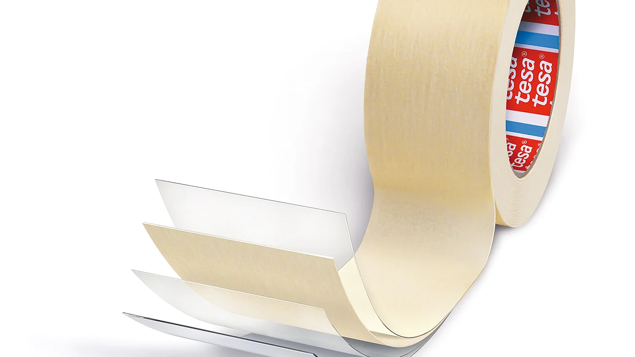 En rulle beige dobbeltklæbende tesa-tape med et delvist udrullet segment, der afslører flere klare lag. Den indvendige del af rullen har rød og blå branding. (This text has been generated by AI)