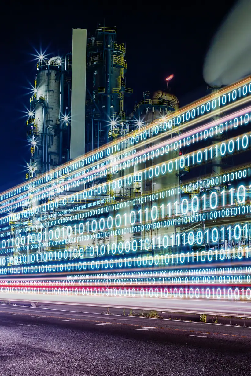 Night cityscape with light trails displaying binary code (0s and 1s) along a road, highlighting digital data flow in an urban setting. (This text has been generated by AI)