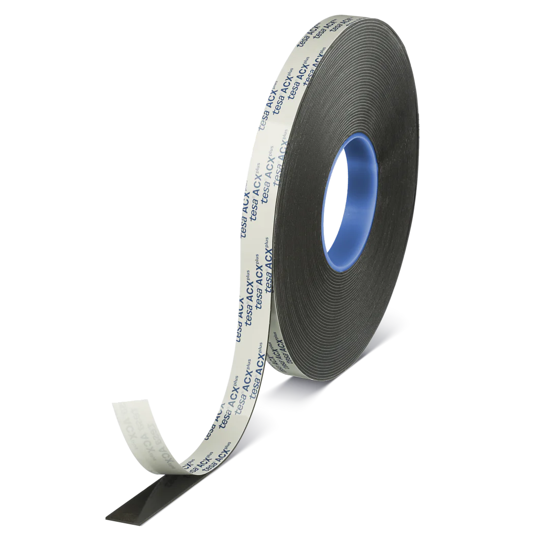 A roll of black adhesive tesa tape with a light gray protective layer being partially peeled back. The inner core of the tesa tape is blue, and the tesa tape is positioned on a gray stand. (This text has been generated by AI)