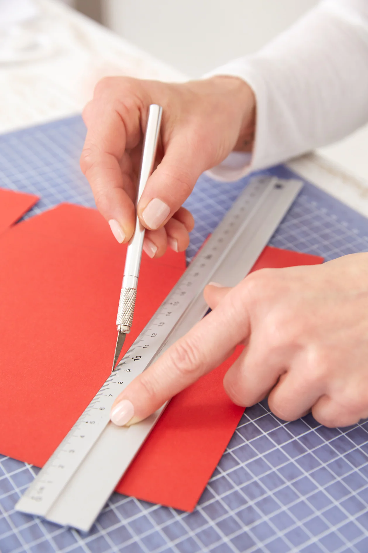 Carve folding lines on the cardboard for the gift bags