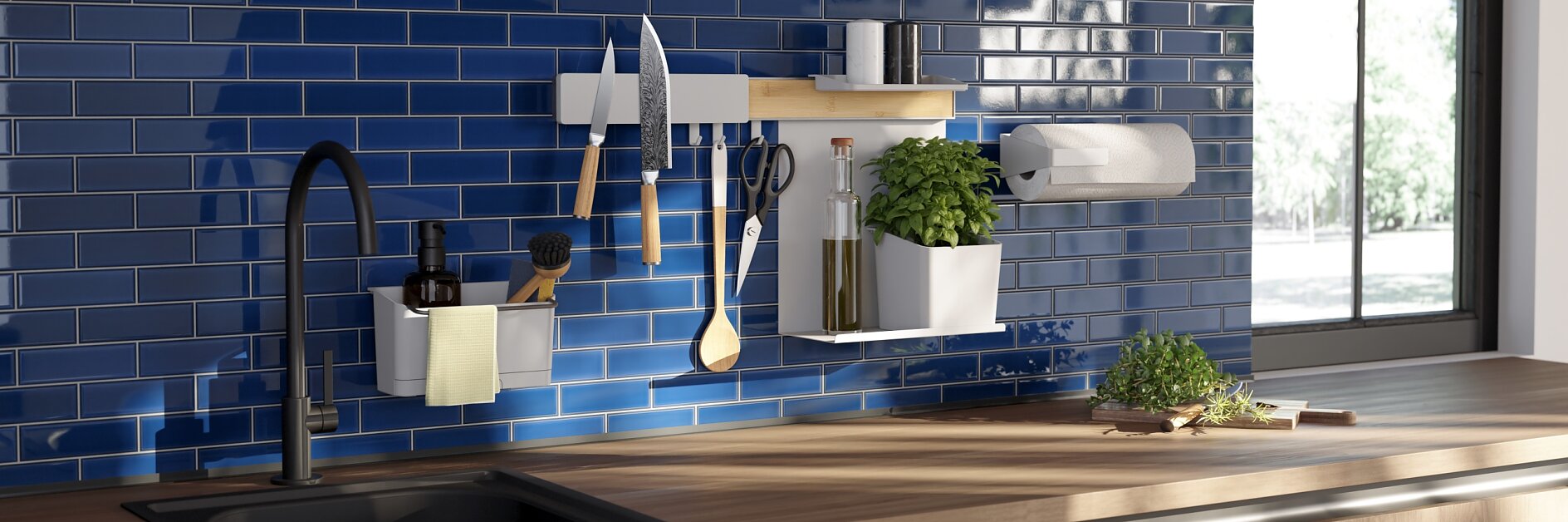 Modern kitchen with blue subway tile backsplash, under-cabinet lighting, and a black faucet. Knives, utensils, herbs, and a paper towel holder are mounted on the wall using tesa tape. Sunlight filters through a window, illuminating the wooden countertop. (This text has been generated by AI)