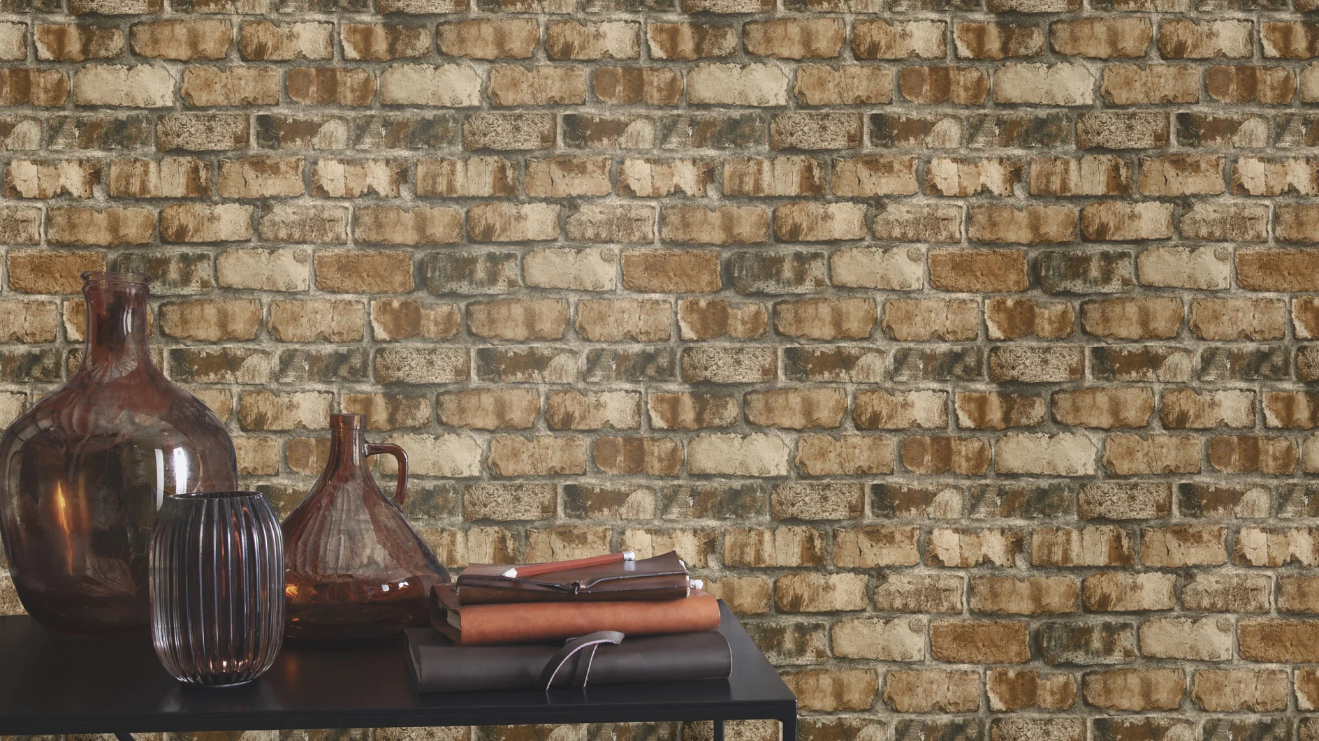 A table with brown glass vases and stacked books is positioned against a wall with a brown and beige brick pattern secured using tesa tape. (This text has been generated by AI)