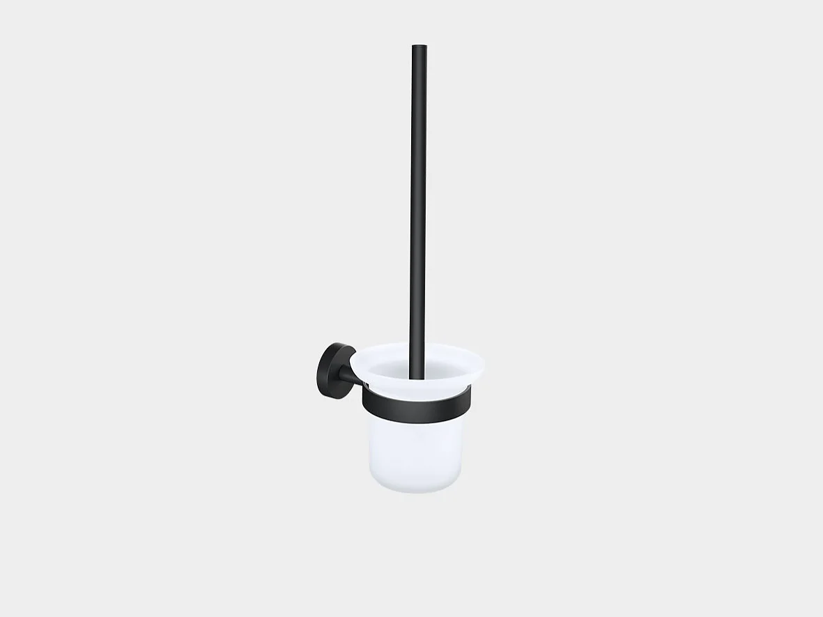 Wall-mounted toilet brush holder with a black handle and mounting bracket secured with tesa tape. The holder is white, cylindrical, and open at the top. The brush is placed vertically inside the holder. The background is plain gray. (This text has been generated by AI)