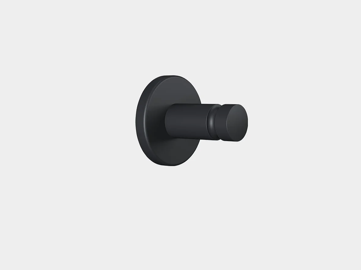 A black cylindrical wall hook mounted on a flat circular base against a plain light gray background secured with tesa tape. (This text has been generated by AI)