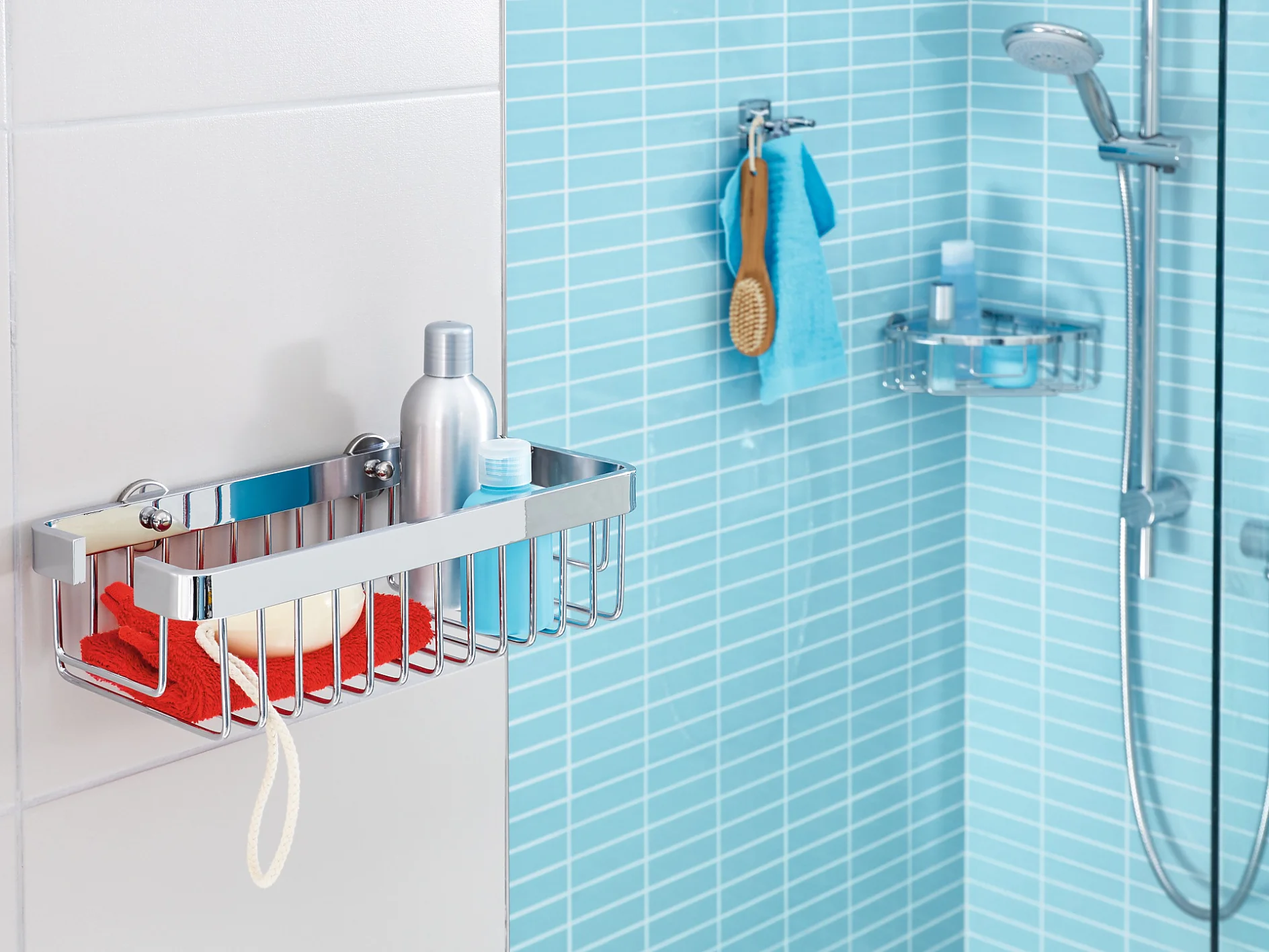 A modern bathroom with light blue tiles features a wall-mounted metal shower caddy holding a red cloth, a soap bar, and a bottle. A showerhead with an adjustable arm is on the right, along with a hanging washcloth and broom nearby. The installation is secured using tesa tape for added stability. (This text has been generated by AI)