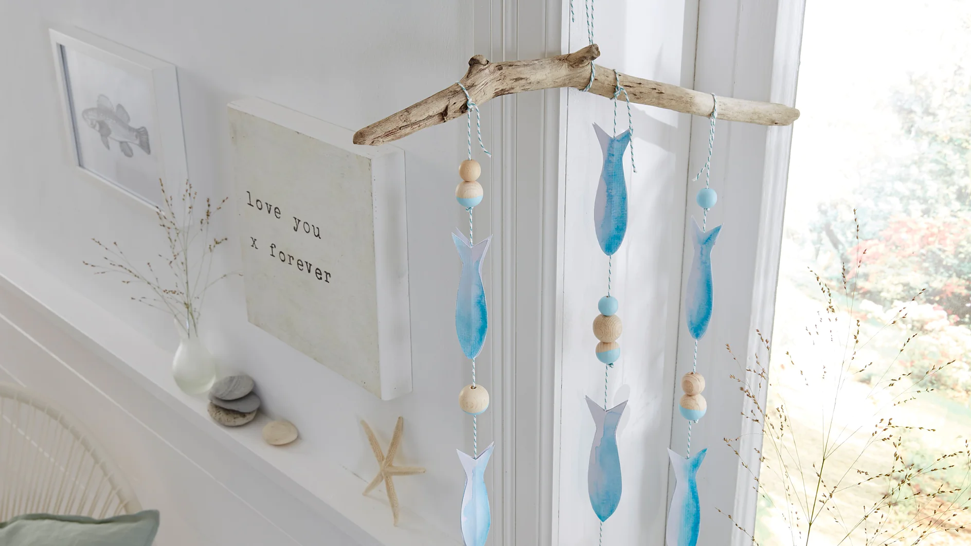 Einfach mal hängen lassen, das selbst gemachte maritime Mobile mit Papierfischen und Holzkugeln. Möglich macht's ein unauffälliger, weil transparenter tesa Powerstrips® Deco-Haken, der nach Benutzung wieder spurlos verschwinden kann.