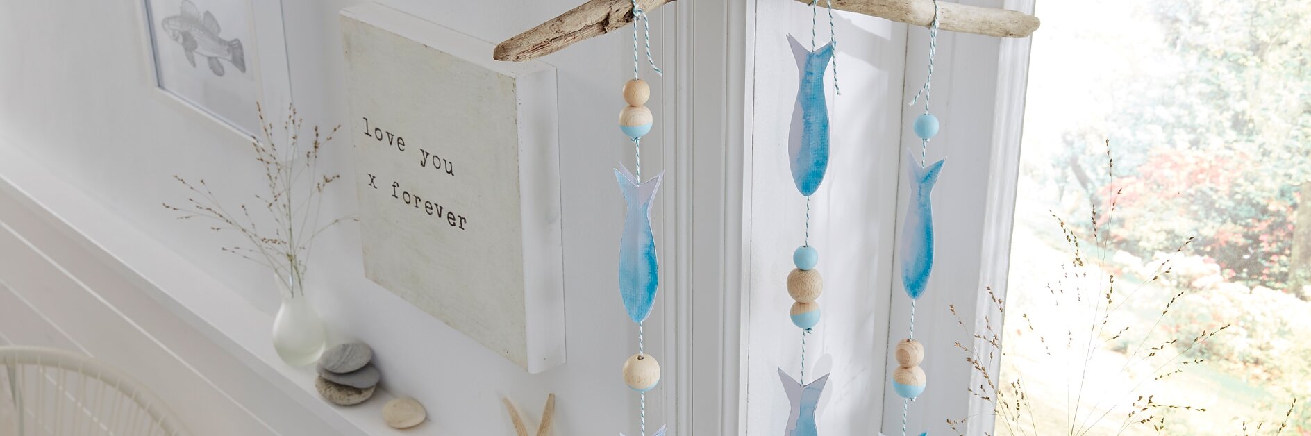 Einfach mal hängen lassen, das selbst gemachte maritime Mobile mit Papierfischen und Holzkugeln. Möglich macht's ein unauffälliger, weil transparenter tesa Powerstrips® Deco-Haken, der nach Benutzung wieder spurlos verschwinden kann.