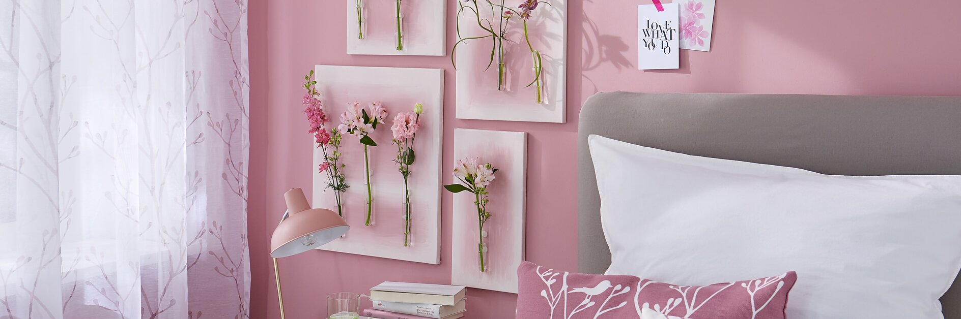 Gemalte Blumen hat jeder an der Wand hängen, aber echte? Dafür braucht man ein wenig Basteltalent, Leinwand, Reagenzgläser, das richtige Klebe-Know-how und natürlich die Hauptdarsteller: mehrere ungewöhnliche Einzelblüten! Hier in abgestuften Tönen von Weiß bis Magenta als schöne Ergänzung zu der rosaroten Umgebung.