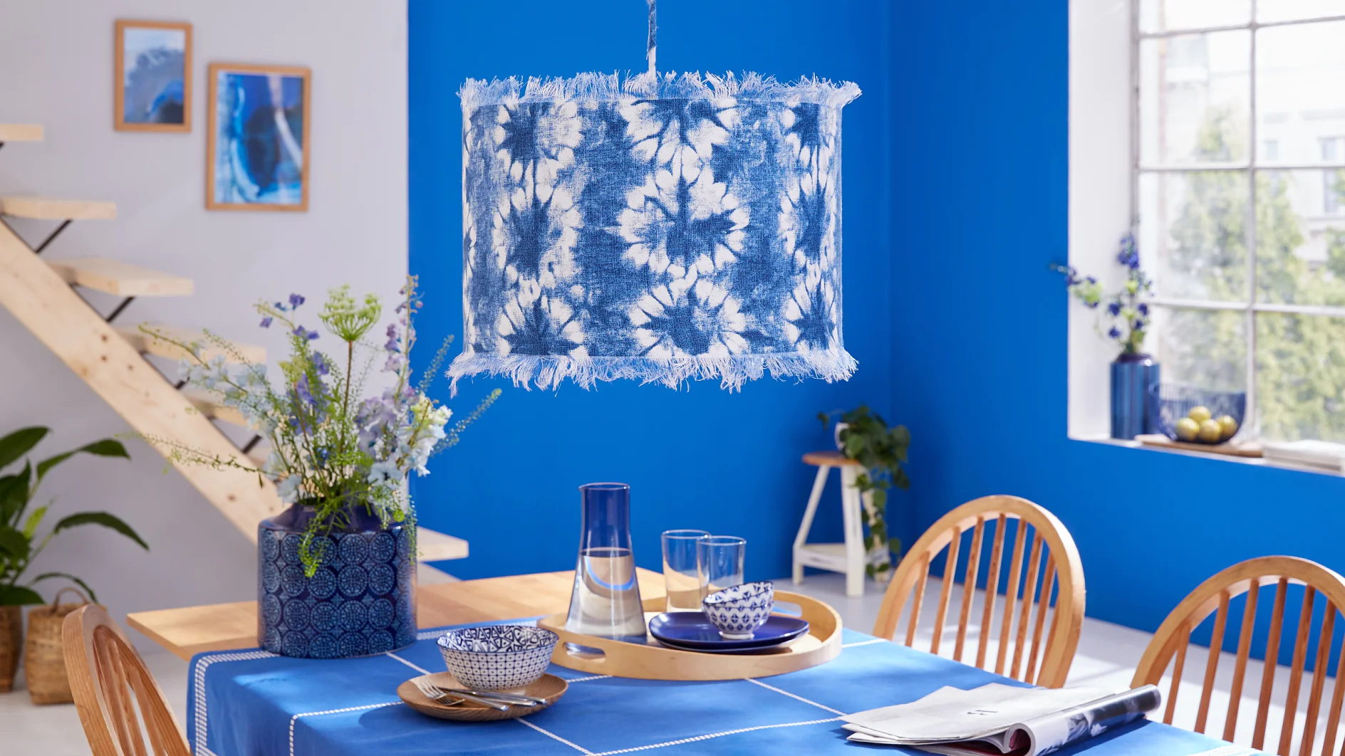 Kein Wunder, dass Blau die Lieblingsfarbe im Süden ist: Sie wirkt kühl, aber trotzdem wunderbar wohnlich. Hier ist eine mit Batikstoff bezogene Pendelleuchte das berühmte Tüpfelchen auf dem i.
