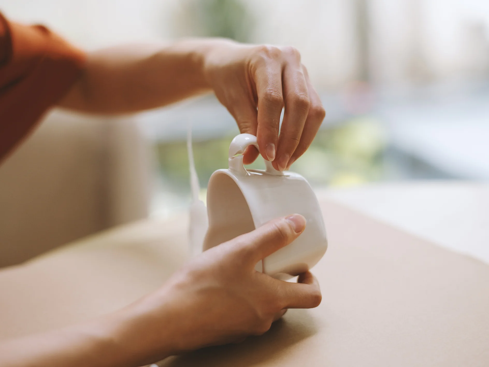 Creative person fixing broken porcelain tea cup