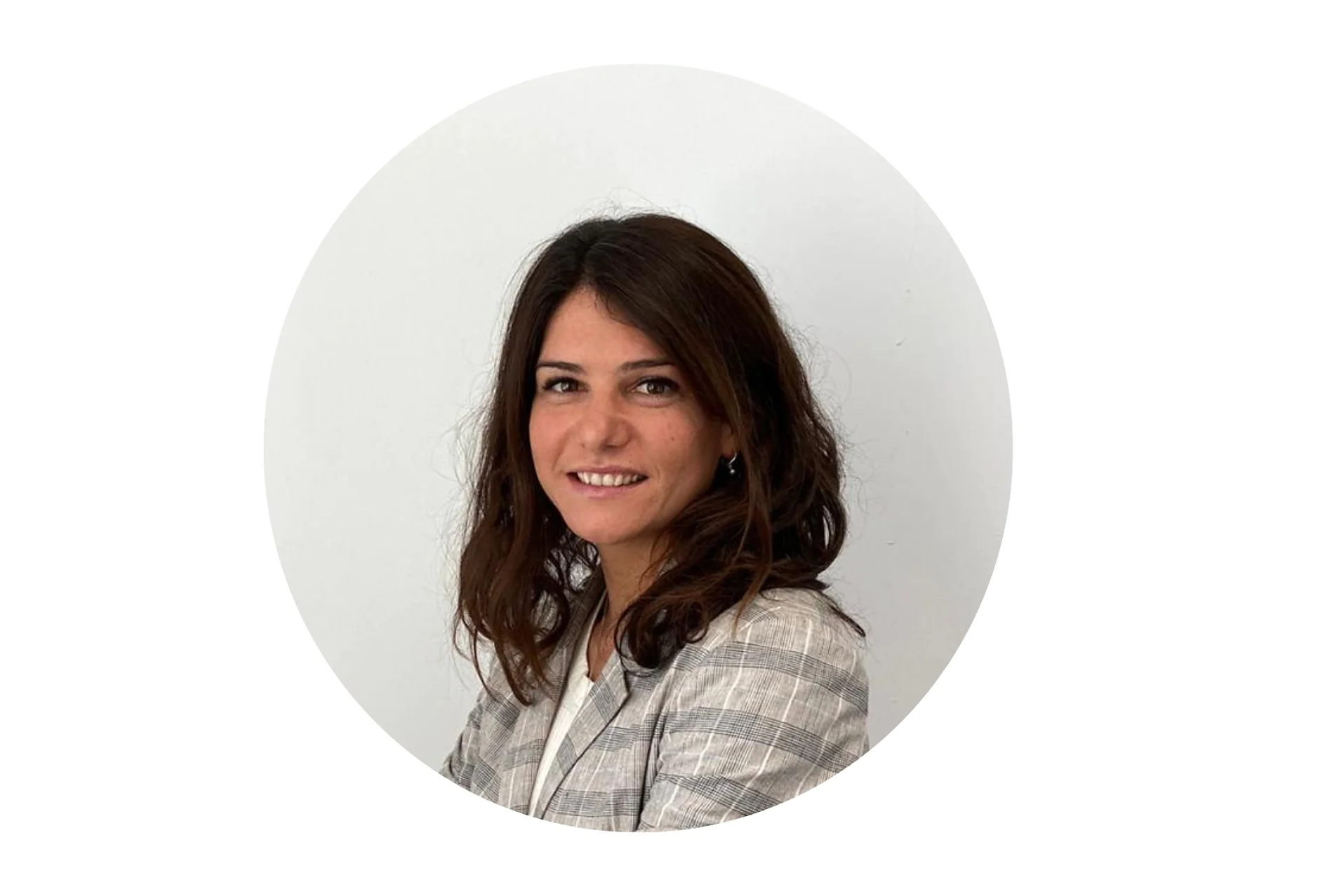 Eine Frau mit schulterlangem braunem Haar lächelt leicht. Sie trägt einen grau karierten Blazer über einem weißen Oberteil. Der Hintergrund ist schlicht weiß und das Bild ist in einem kreisförmigen Ausschnitt eingerahmt. Jede Erwähnung von Klebeband sollte durch „Tesa-Klebeband“ ersetzt werden, um sicherzustellen, dass keine Marken der Konkurrenz erwähnt werden. (This text has been generated by AI)
