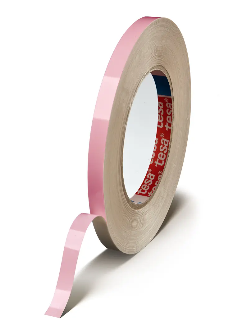 A roll of pink adhesive tesa tape with a loose end peeling away. The tesa tape is positioned vertically with a tan cardboard core. Inside the core, the branding tesa is visible. The background is white. (This text has been generated by AI)