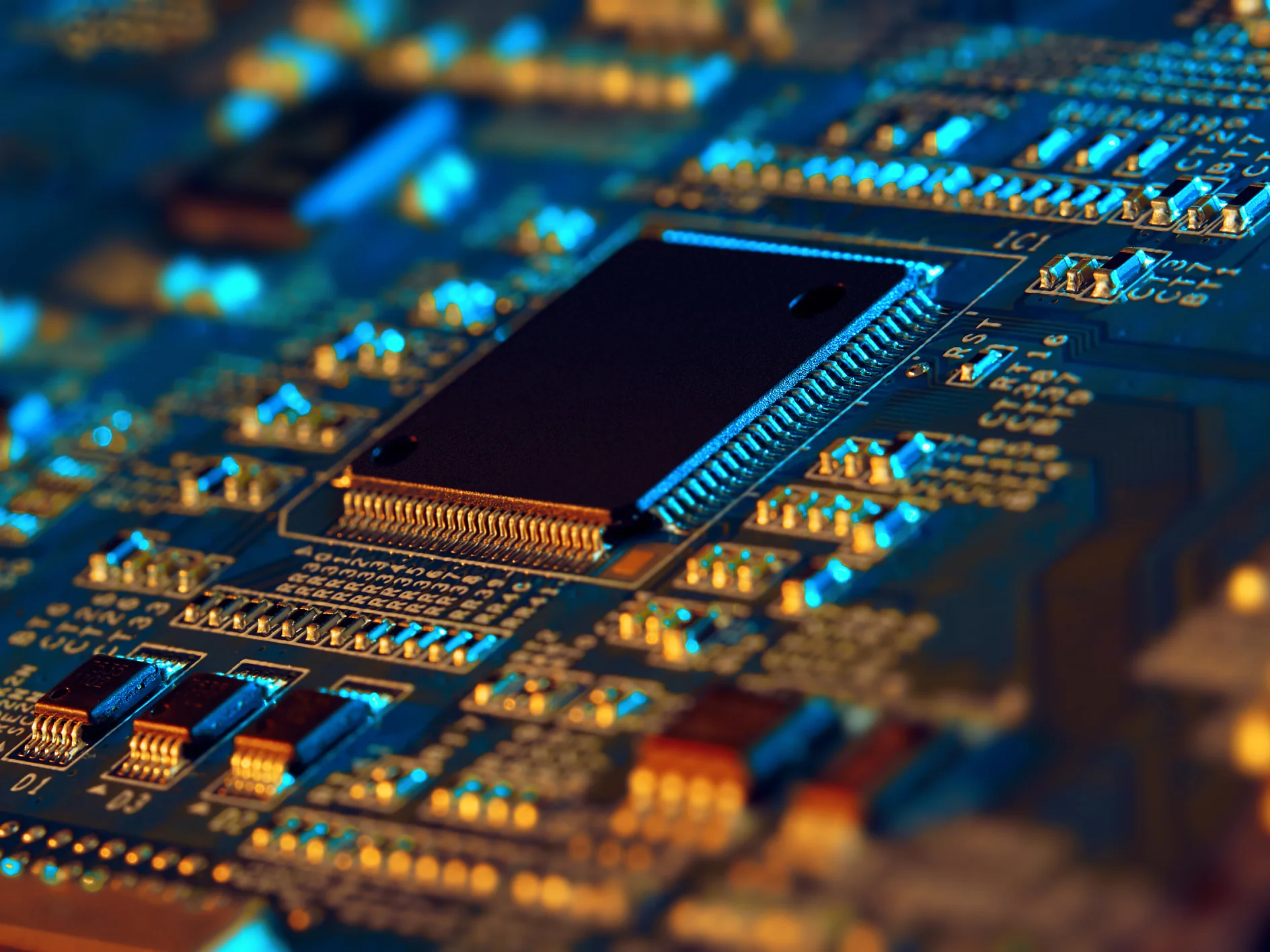 Close-up of a computer motherboard with a central processor unit. The image highlights circuit paths and electronic components in blue and orange lighting, providing a detailed view of the intricate motherboard design. (This text has been generated by AI)