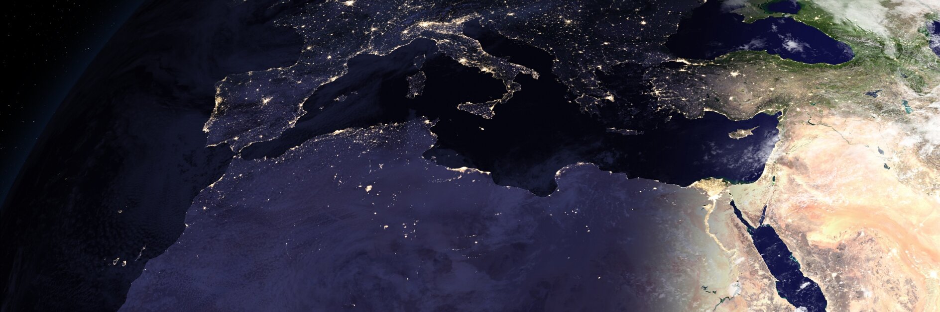 Satellite view of Europe, North Africa, and the Middle East at night, showing city lights and clear tesa tape-like day/night shadow.