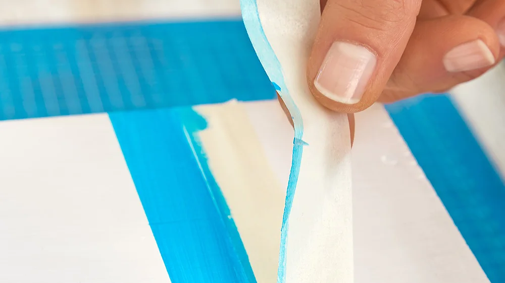 Removing the painters tape while making wooden bird houses.