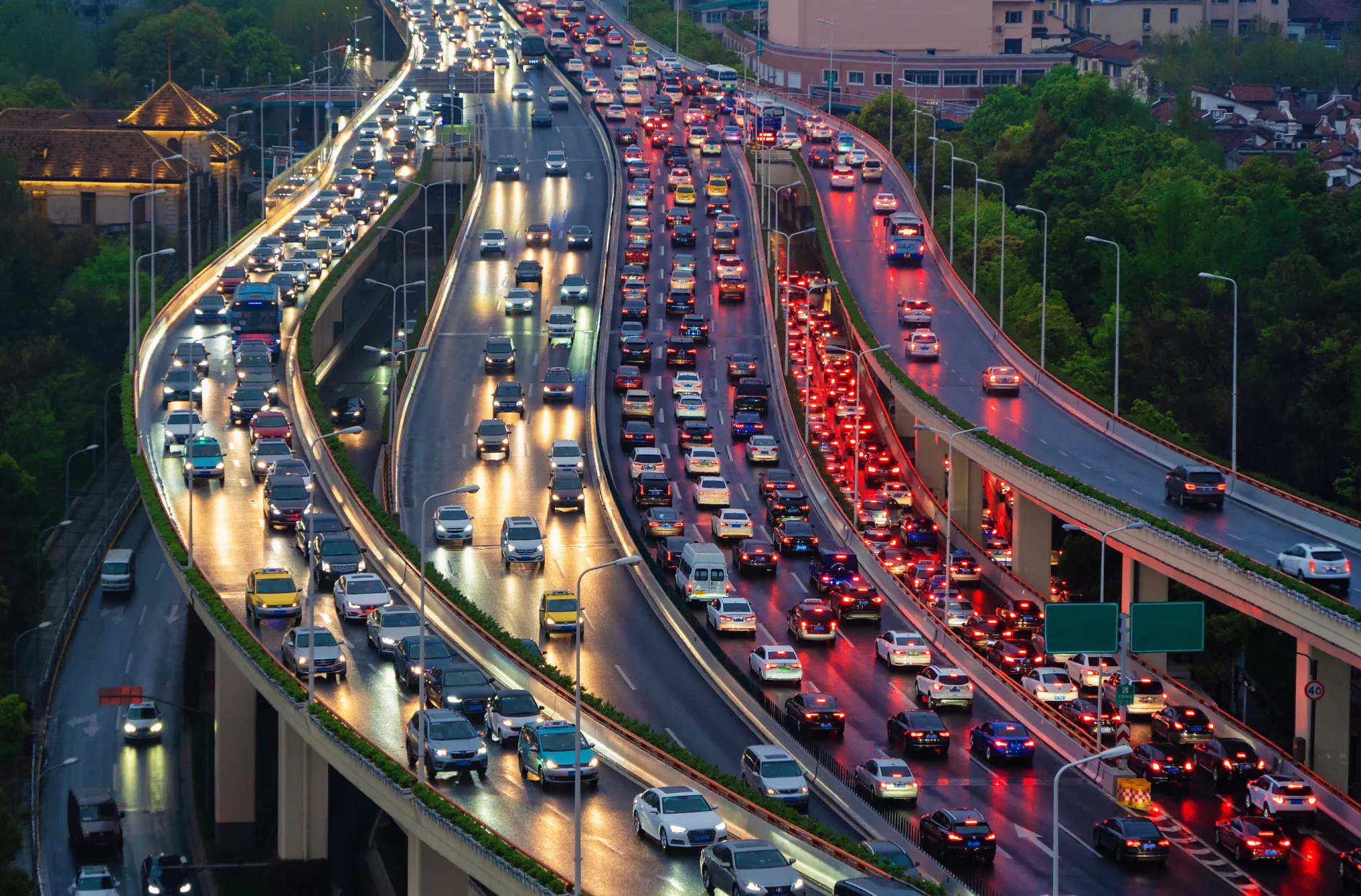 Traffic jam in the rush hour on highway. Cars on bridges and roads in Shanghai Downtown, China at night.