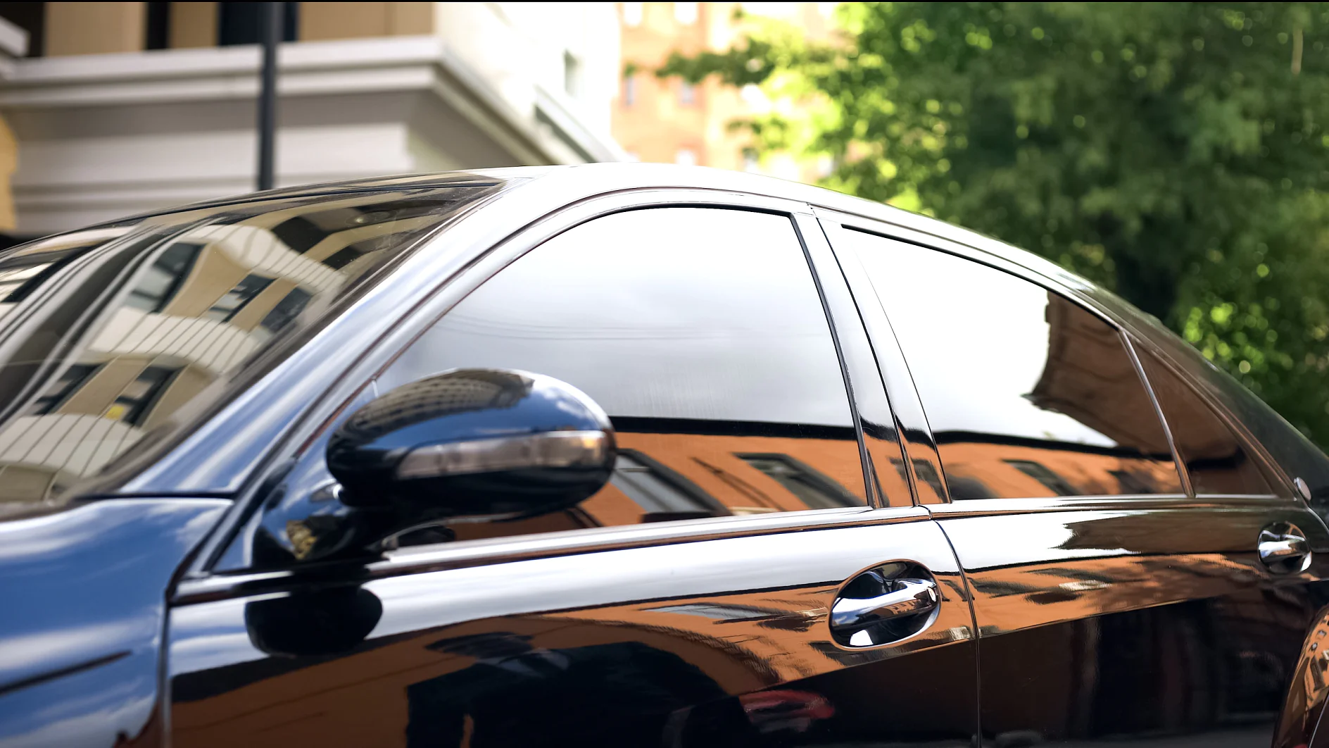 Luxury car with tinted glass standing at parking, reflection of businessman Luxury car with tinted glass standing at parking, reflection of businessman