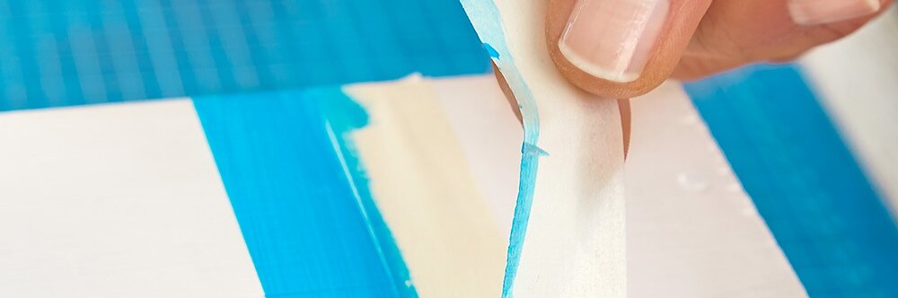 Removing the painters tape while making wooden bird houses.