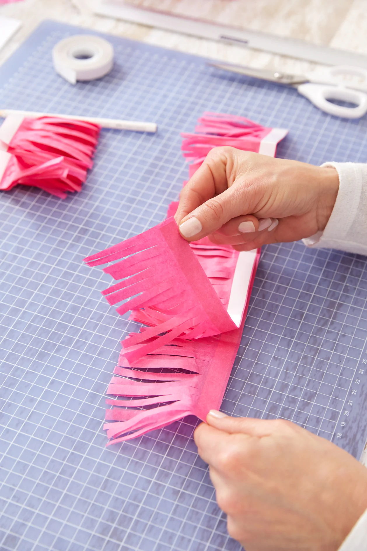 Unfold the strips to create a pompom