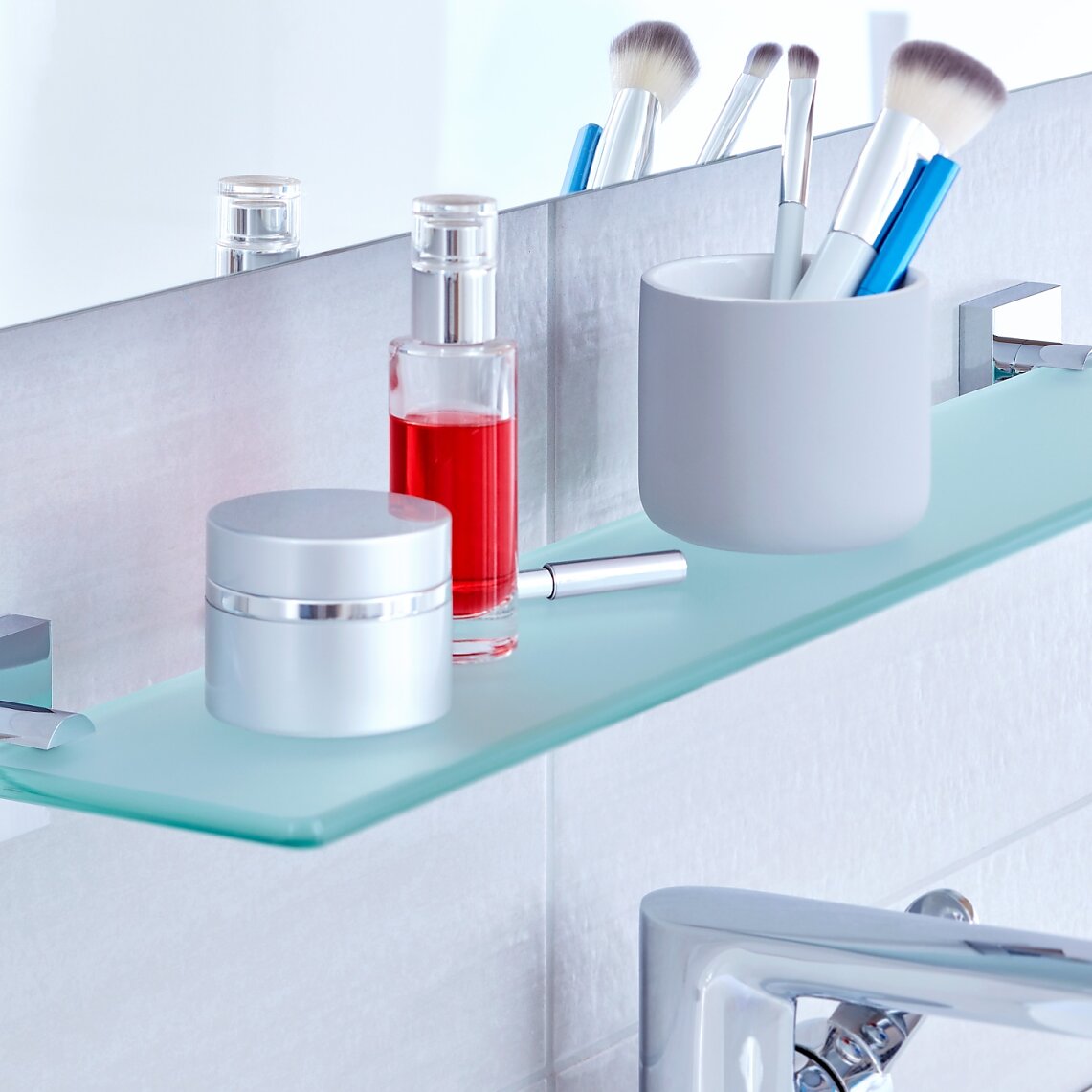 Glass Shelf 1 Use the space below your bathroom mirrors by mounting an elegant frosted glass shelf to the wall.