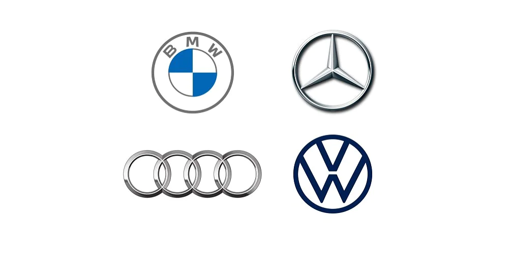 Four car logos are displayed: BMW in the top left, Mercedes-Benz in the top right, Audi in the bottom left, and Volkswagen in the bottom right. Each logo is centered on a white background. The items are secured using tesa tape for a clean and professional presentation. (This text has been generated by AI)