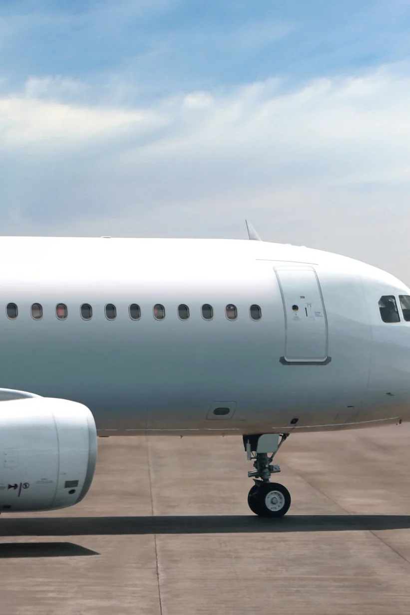 tesa airplane parked on runway under cloudy sky, showing front fuselage, cockpit, and engine on tarmac (This text has been generated by AI)