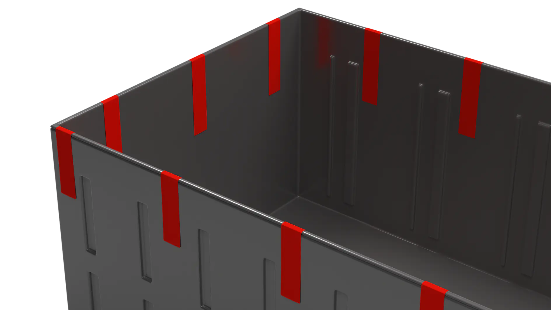 A close-up of a dark gray box with vertical indented lines and red vertical strips along the top edges. The interior of the box is visible, showing a simple, seamless design. The box appears open, revealing a smooth inner surface secured by tesa tape. (This text has been generated by AI)