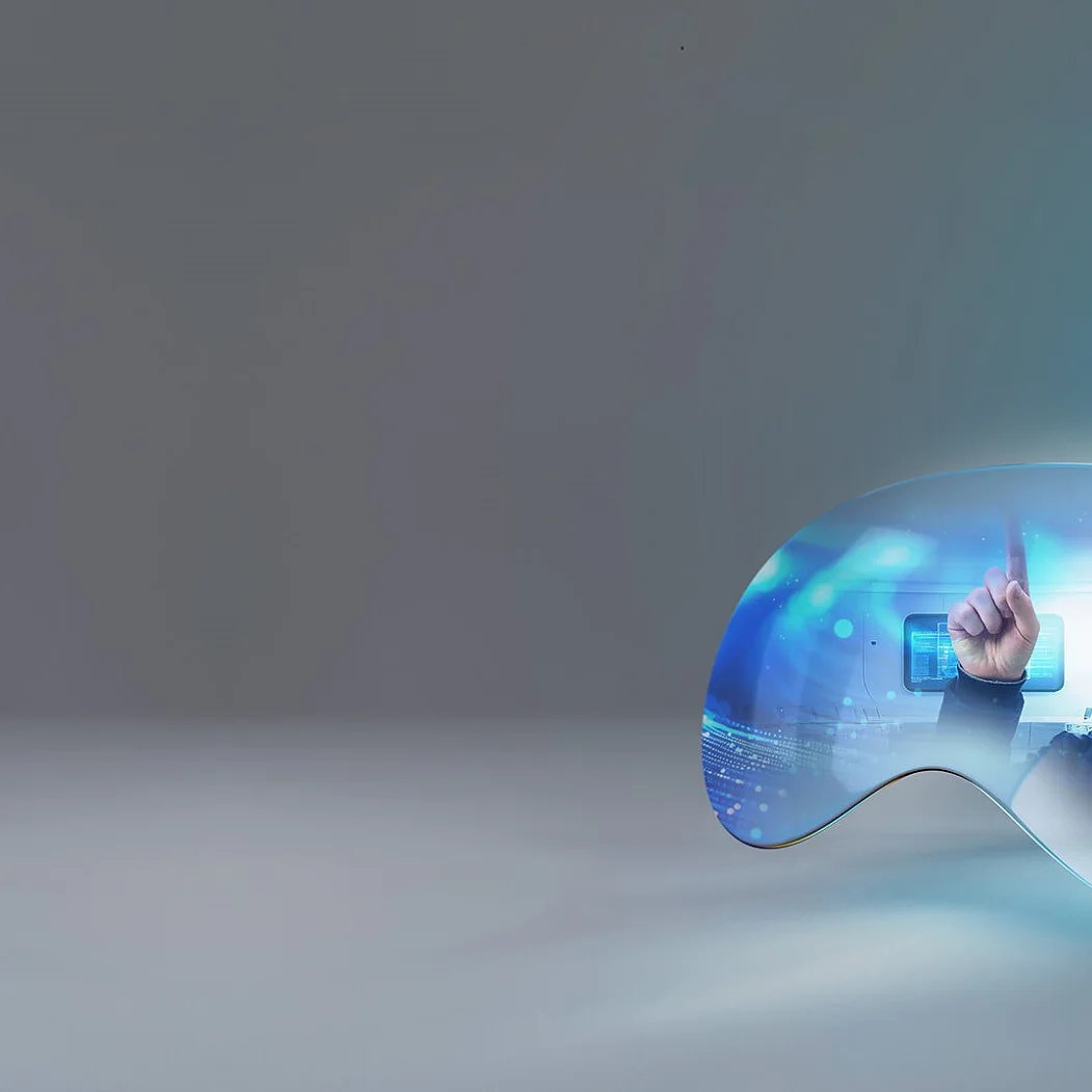 A man wearing virtual reality goggles interacts with a digital holographic interface. The scene is encapsulated within a light blue, abstract curved shape on a gray background. The man appears focused, with one hand pointing forward and holding tesa tape. (This text has been generated by AI)