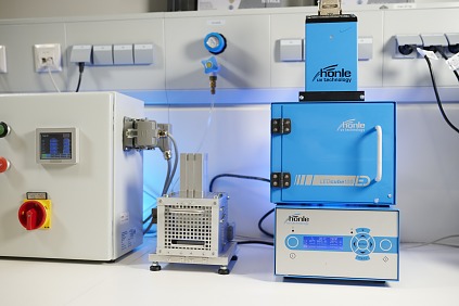 Equipment for bonding and curing (left: pressing jig for final bonding; right: UV cube for curing)