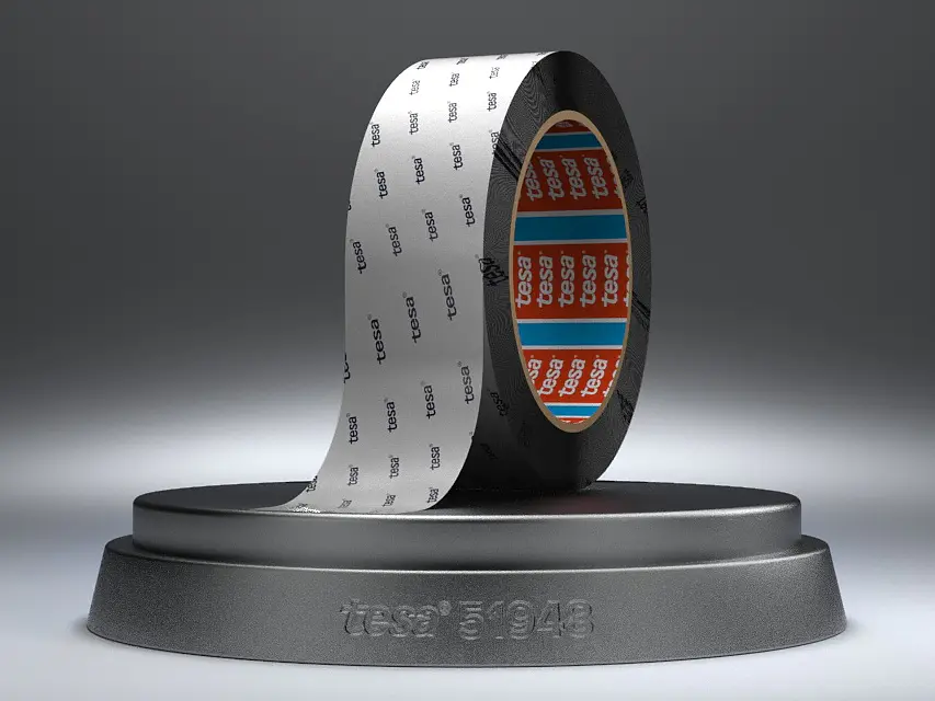 A roll of Intel 8048 labeled tesa tape, partially unrolled, stands on a round black platform. The inside of the tesa tape is orange with text, and the exterior has a repeating Intel 8048 pattern. The background is a subtle gray gradient.