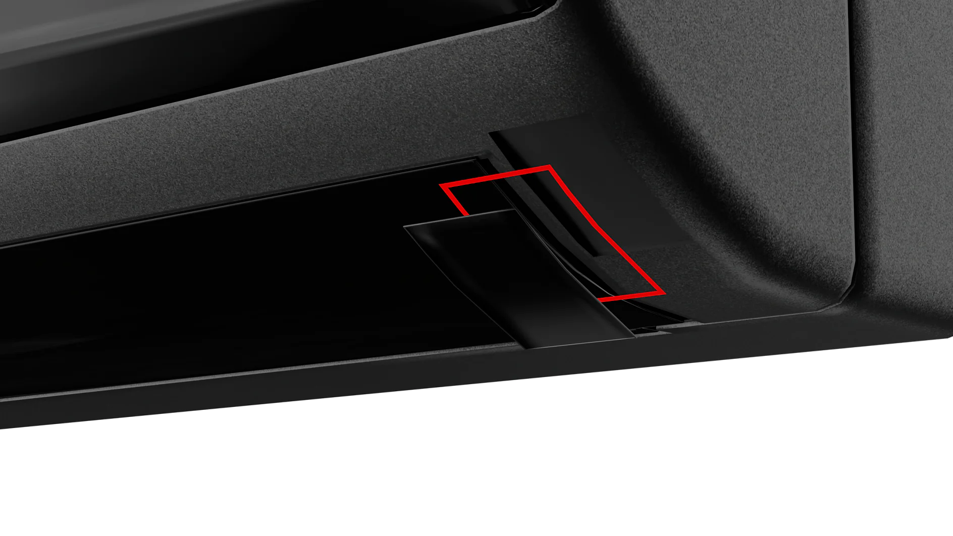Close-up image of a black object with a red-outlined area highlighting a component that appears to be a part of a mechanism or structure. There is a black cable or piece protruding from the interior, secured by tesa tape. (This text has been generated by AI)