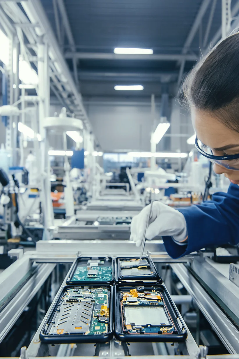 tesa workers assembling electronic components on a production line in a modern factory setting (This text has been generated by AI)