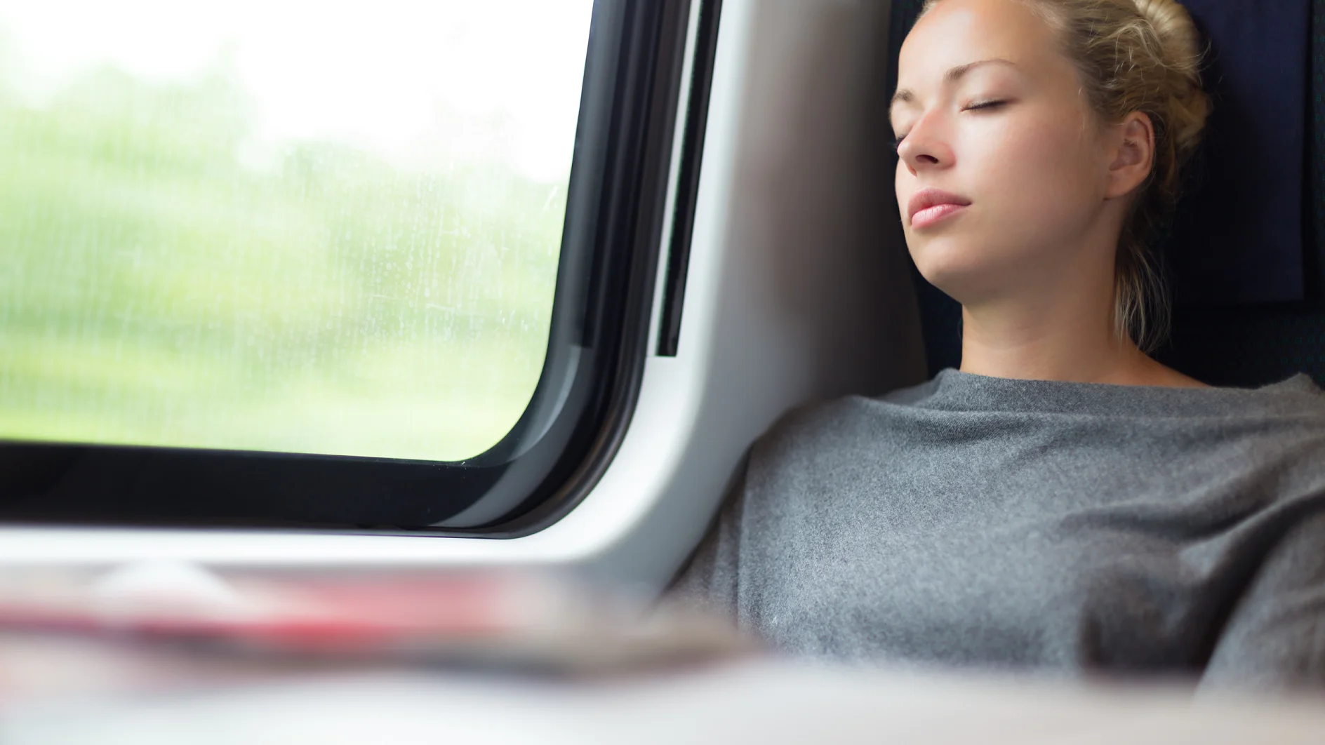 Casual lady napping while traveling by train.