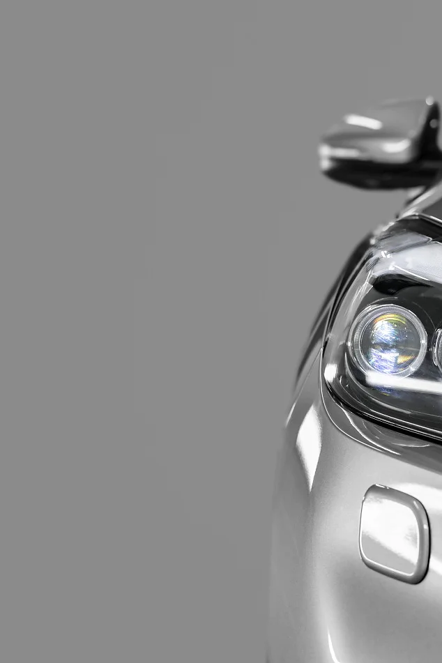 Gray modern car closeup on black background.