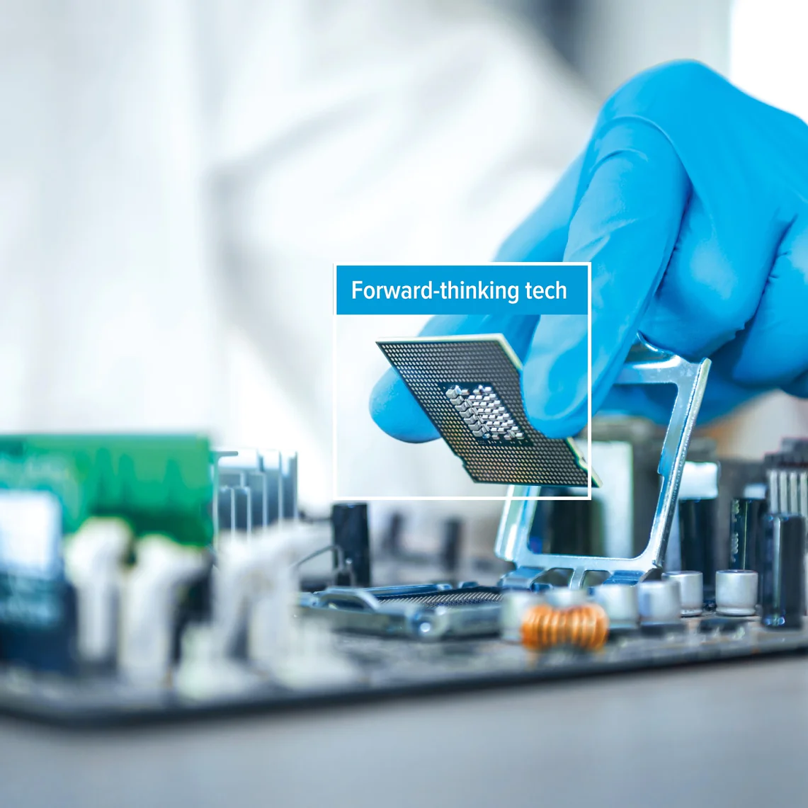 A person wearing a blue glove installs a computer processor onto a motherboard using tesa tape. The phrase Forward-thinking tech appears over the processor. (This text has been generated by AI)