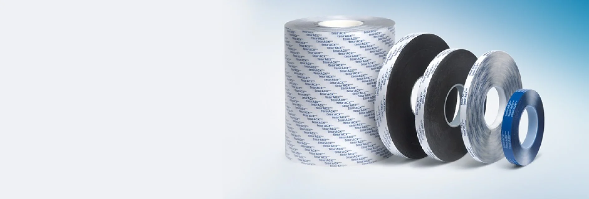 ACX.jpg A gradient blue background with a set of five rolls of various tesa tapes, each increasing in width, labeled with repeated text. The largest roll is on the left, and the smallest roll is on the right, each featuring different patterns and colors. (This text has been generated by AI)