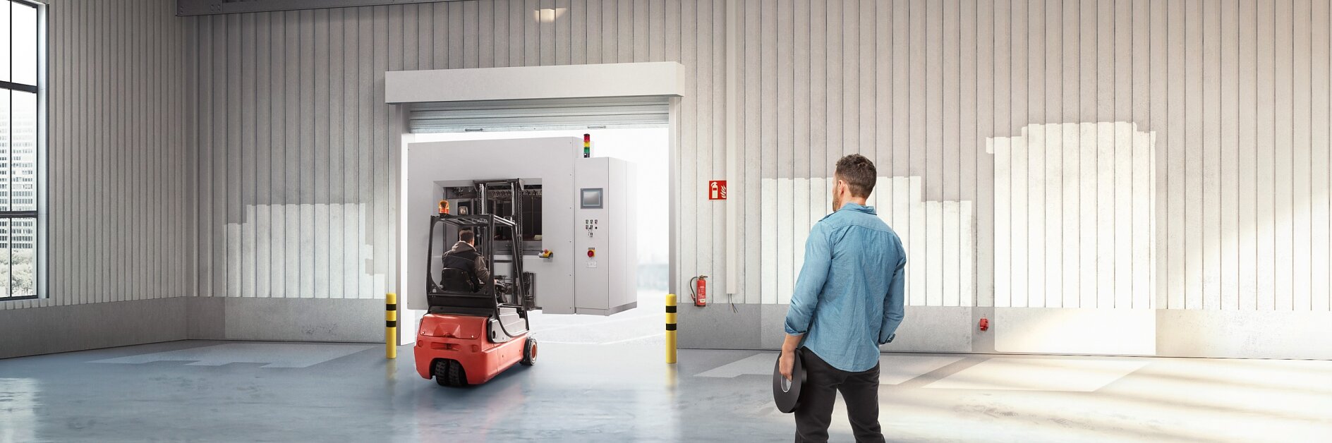 A small stack of products in boxes sitting on a manual pallet jack in a loading dock door at a distribution warehouse.