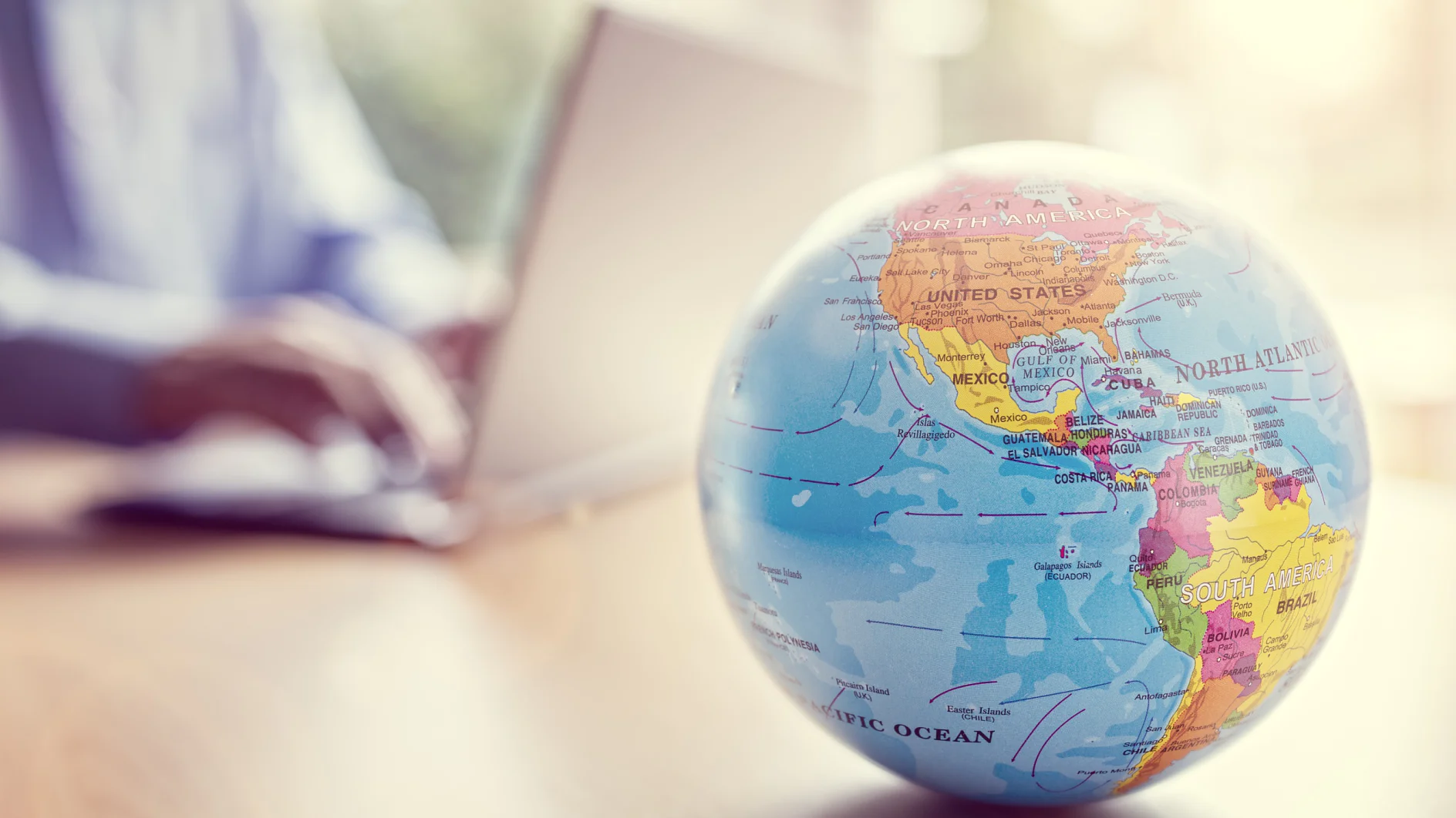 Businessman using a laptop with close up on world globe