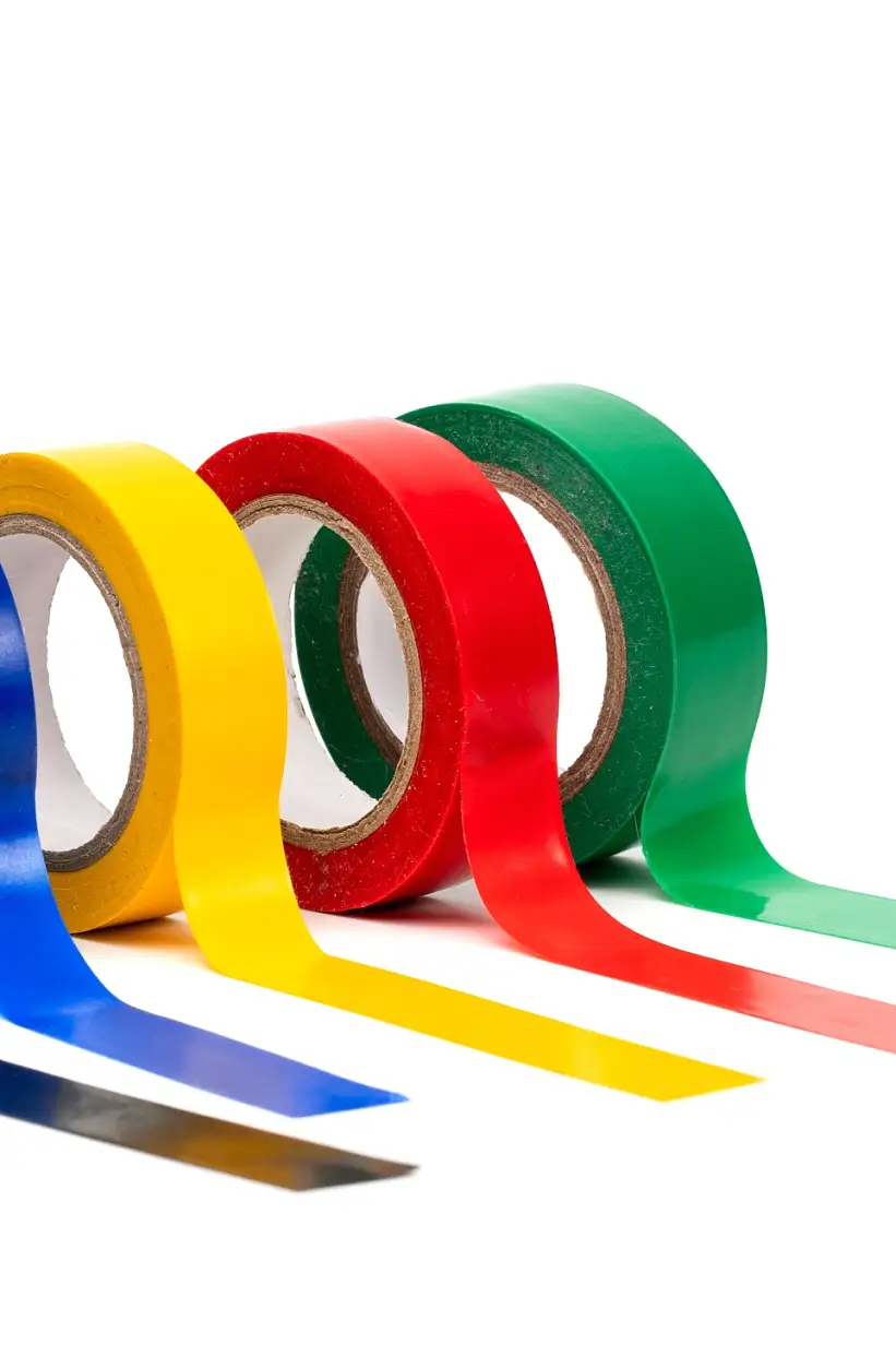 Rolls of insulation adhesive tape, multi colored ribbons on a white background. Bright and colorful insulation tape.