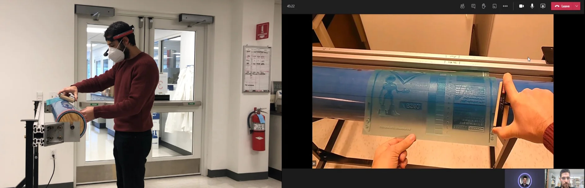 A person in a red sweater and protective mask inspects a roll of tesa tape near a laboratory entrance. To the right, a video call screen shows the same persons hands holding a semi-transparent cylindrical object with embossed designs. (This text has been generated by AI)