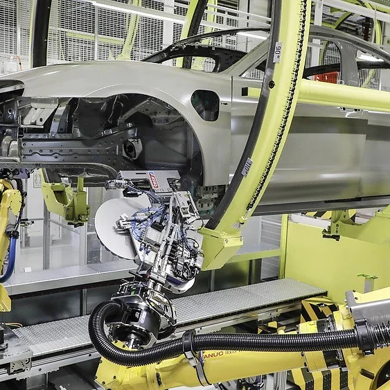 Hole covering process The alternative to plastic plugs: sealing patches from the adhesive manufacturer tesa, which a robot positions quickly and reliably. (© Porsche AG / tesa SE)