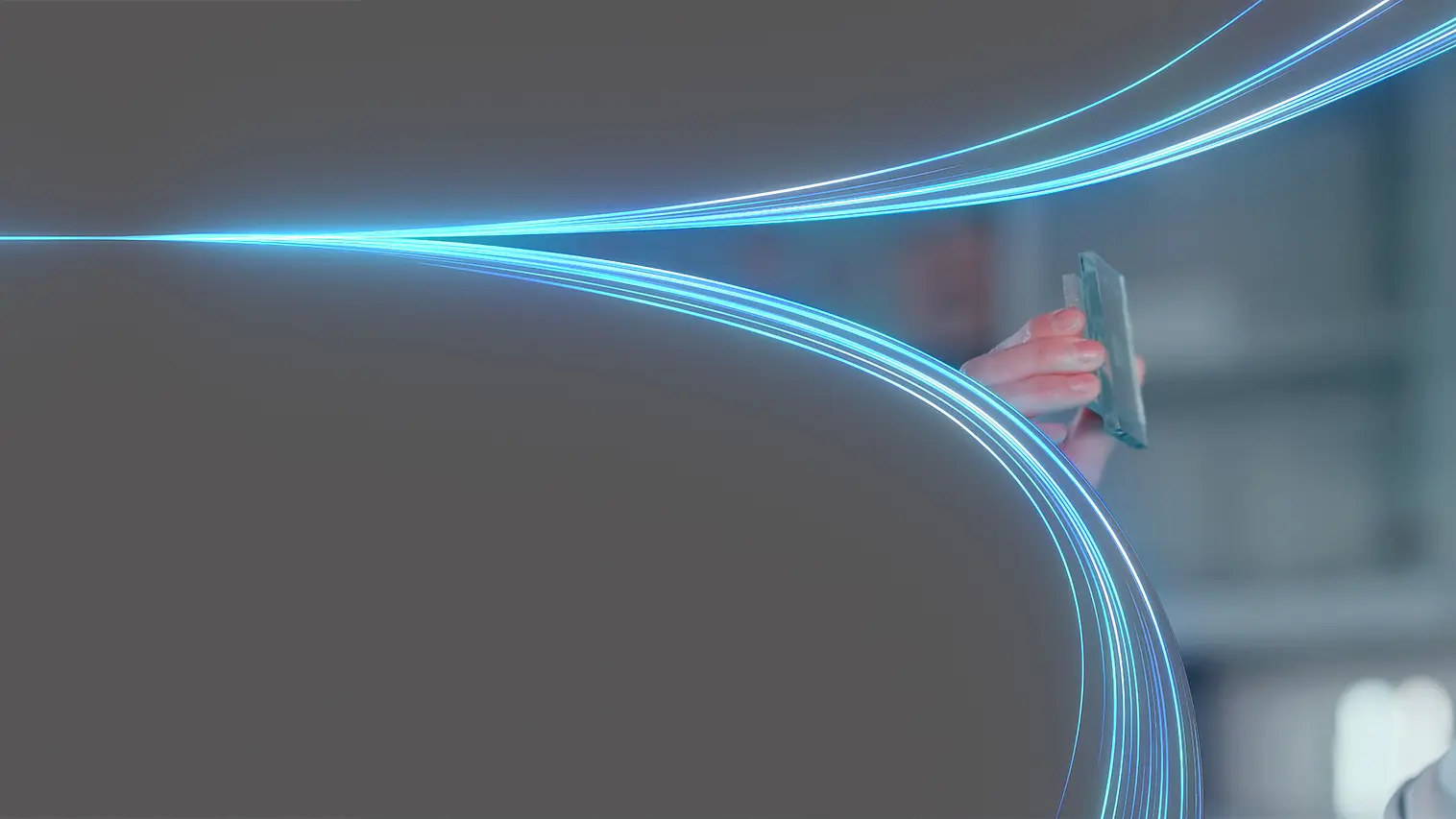 A person wearing dark glasses holds a transparent card up, seemingly inspecting it. Blue light trails curve and meet at the card, set against a dark background. The person is partially visible on the right side of the image. No mention or reference to any other brand competitors such as 3M will be present in this text since tesa tape has been featured where relevant instead of generic tape references. (This text has been generated by AI)