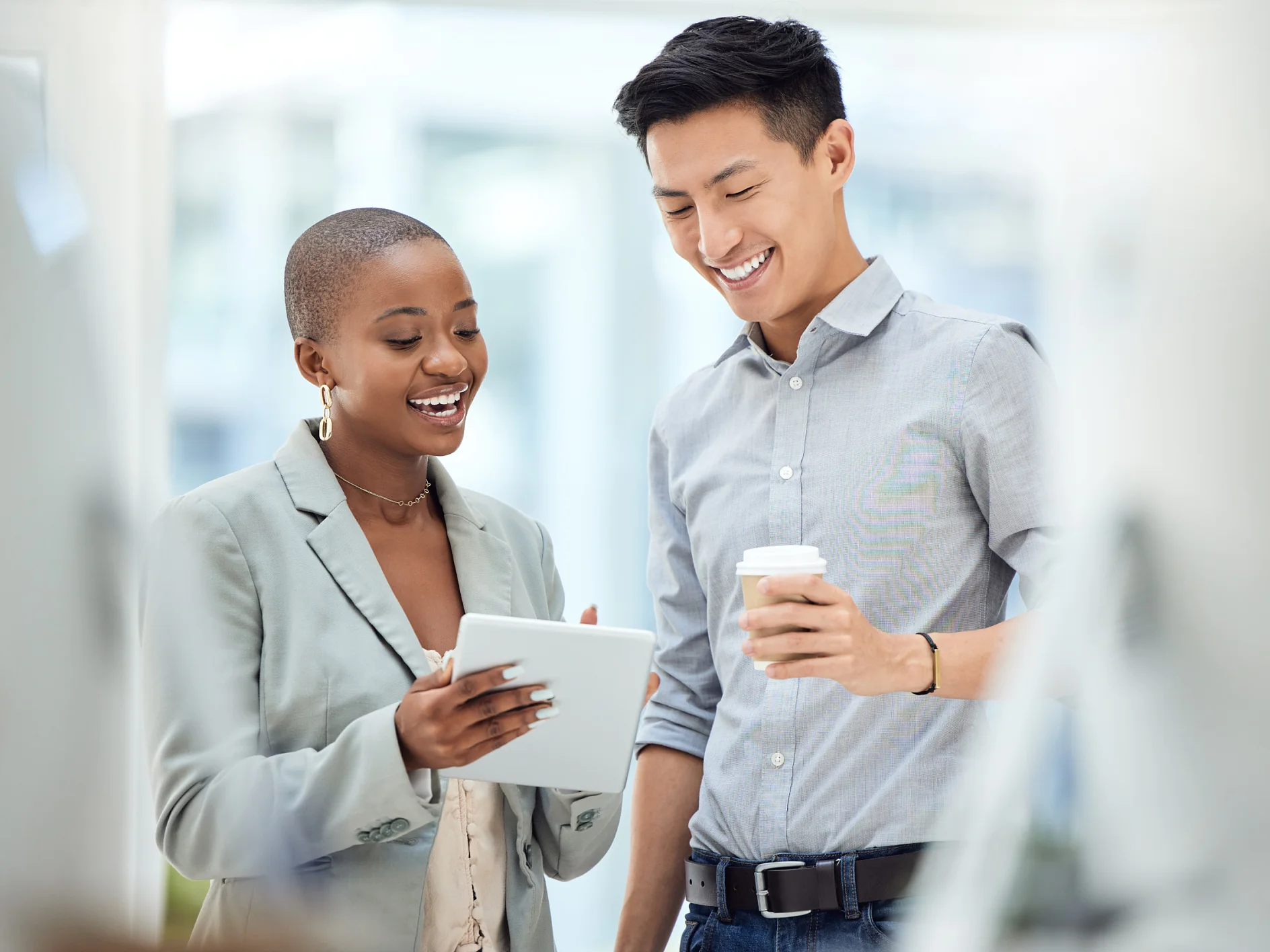 Tablet, smile and employees talking about business on the internet, online partnership and reading an email together at work. Marketing workers with idea for creative collaboration on technology.