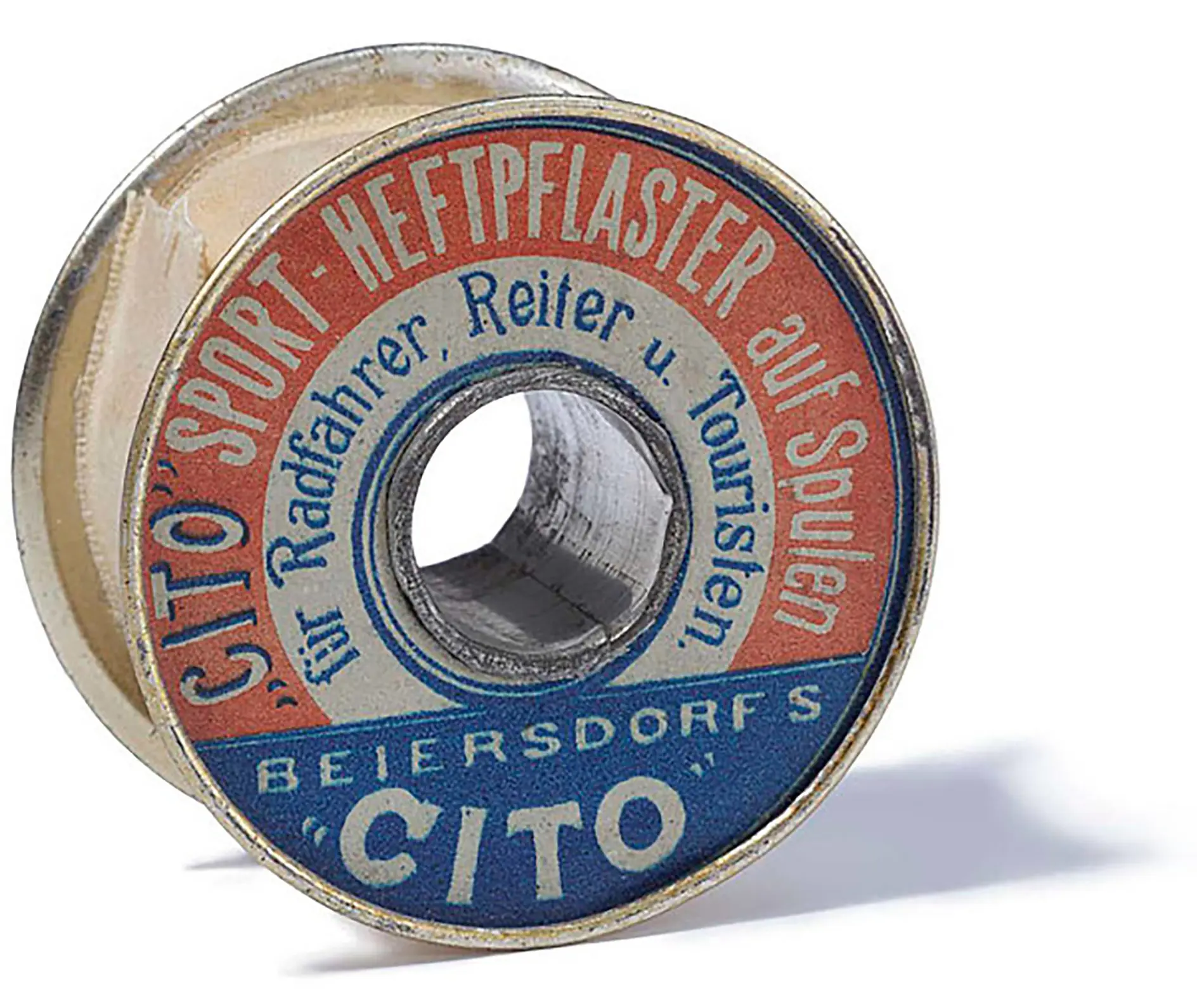 A vintage metal spool labeled Cito Sport Heftpflaster with text in German, featuring red, blue, and white colors. The label indicates it is for cyclists, riders, and tourists. The brand Beiersdorfs tesa tape Cito is visible.