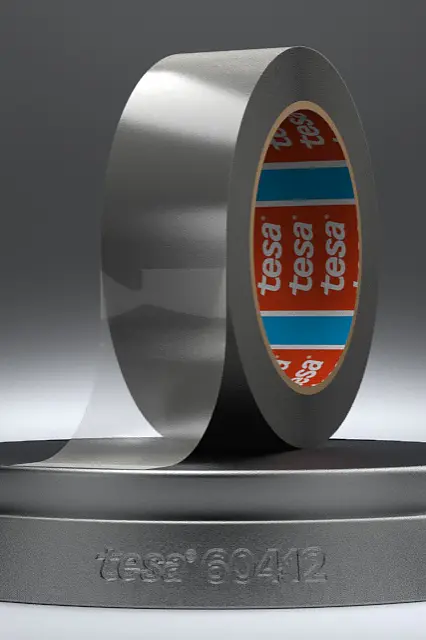A roll of silver adhesive tesa tape is displayed on a metallic stand with the text tesa and 60412 engraved on it. The tesa tape is partially unrolled, and the inner core of the roll features a red and blue pattern with the brand tesa clearly visible. (This text has been generated by AI)